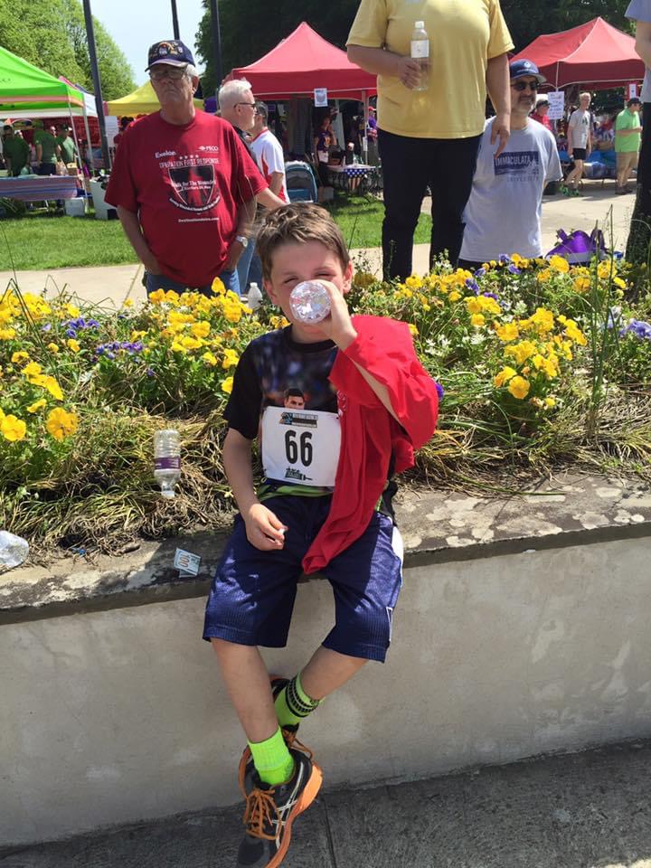 Young Parker after a race, drinking water