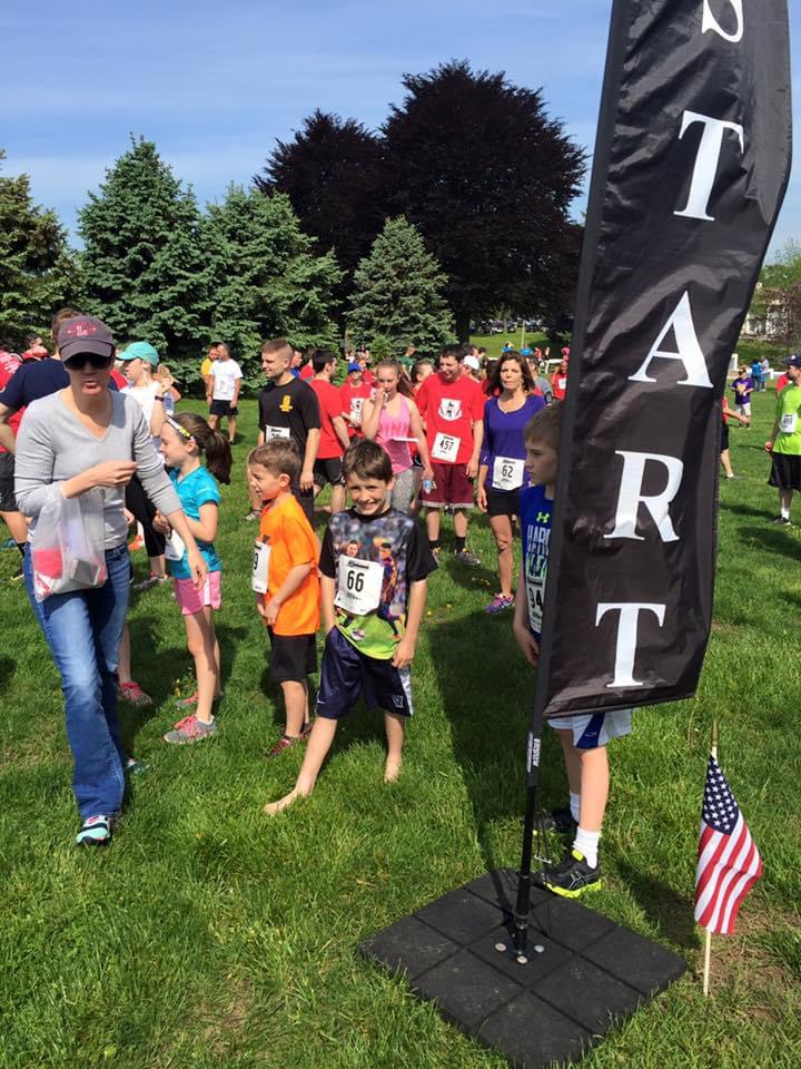 Young Parker at the starting area of a 5K with other runners